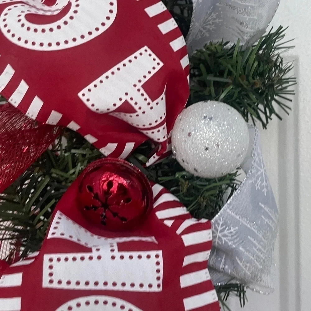 Handmade Christmas wreath, ribbon,bells, and ornaments. Silver, white and red